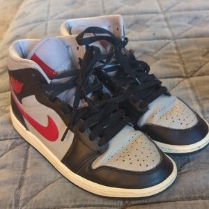 Nike Air Jordan 1 Mid in the "Black/College Grey/Sail/Gym Red" colorway